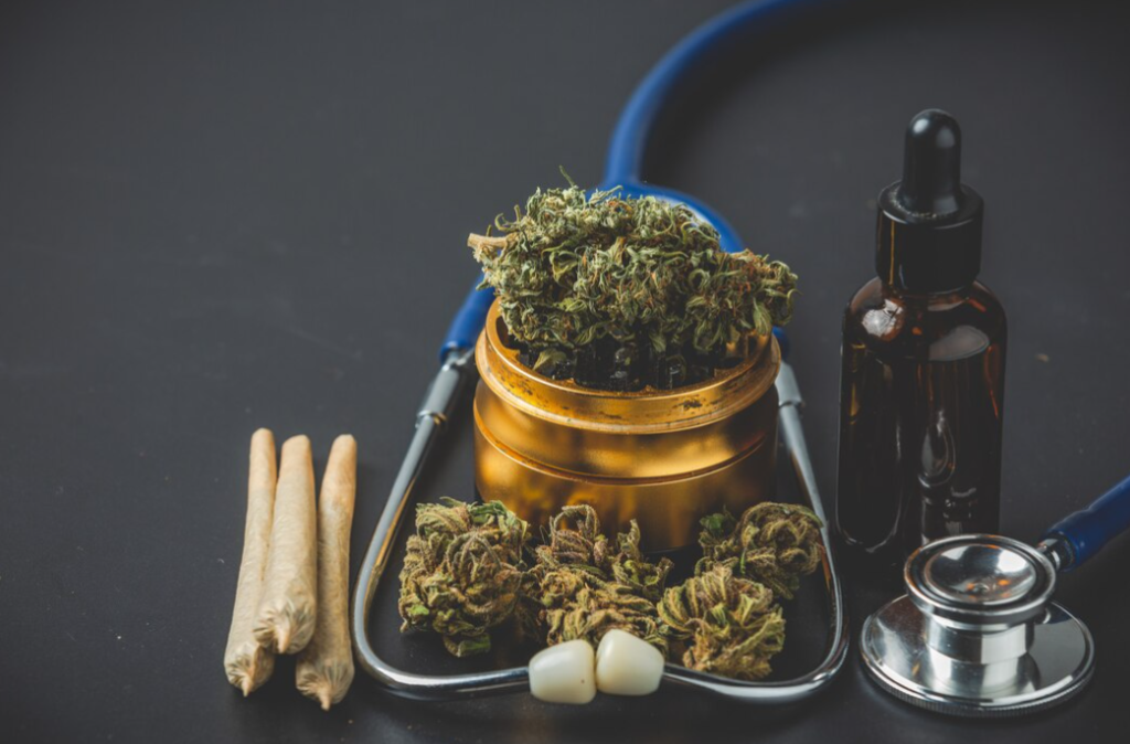 stethoscope, medical marijuana, cannabis buds, and joints  on dark table 